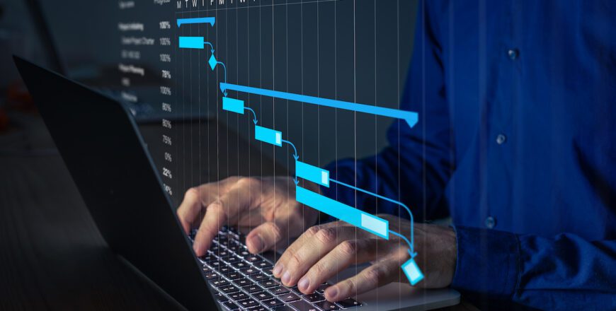Project manager working on Gantt chart to update the schedule, tasks and milestones progress for the team. Management diagram on computer screen with person coordinating teamwork.